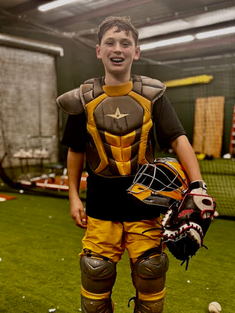 Young baseball catcher geared up