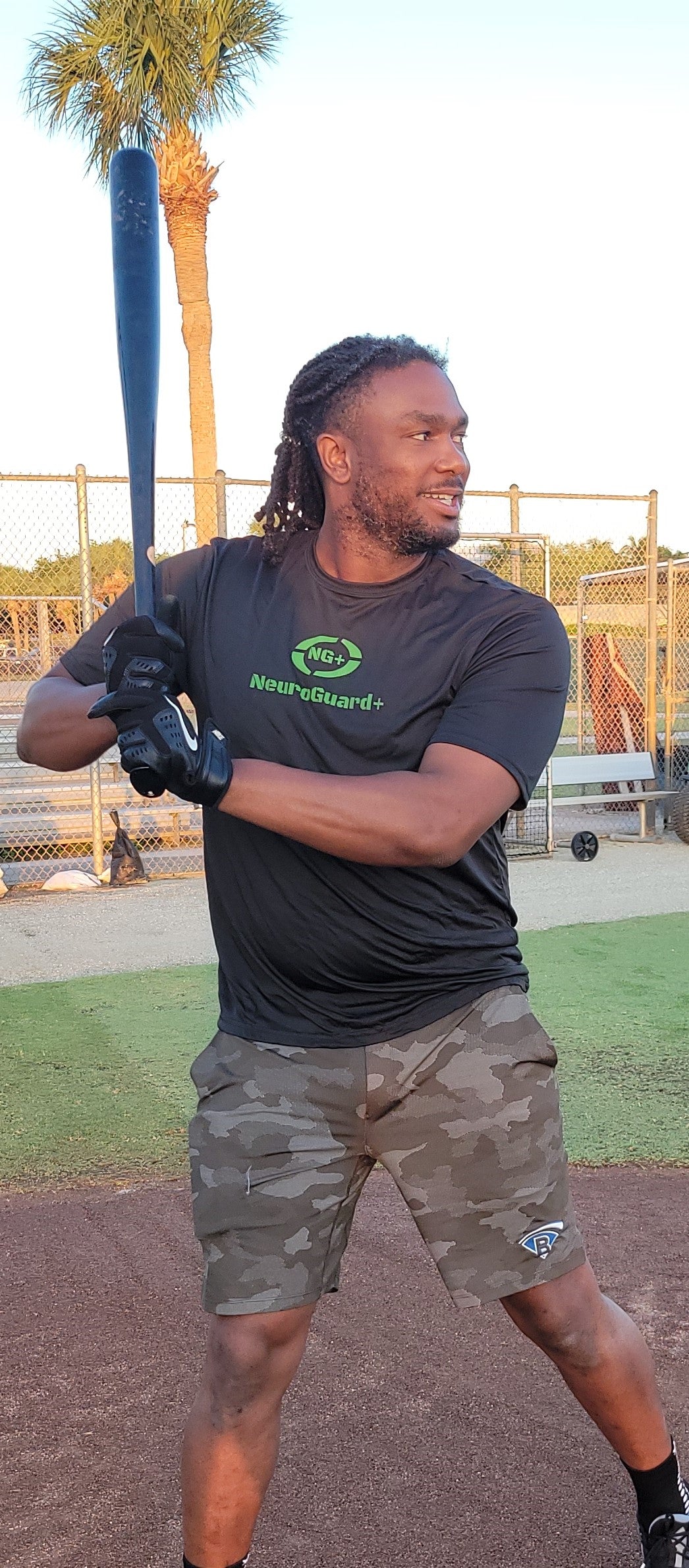 Josh Bell holding his NeuroGuard+ before batting practice