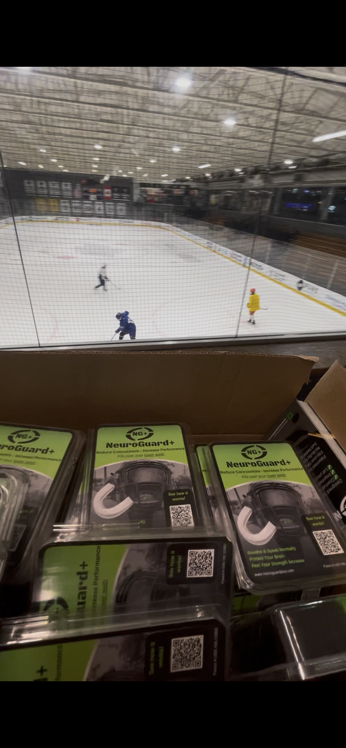 Case of NeuroGuard+ retail packs rinkside